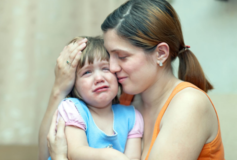 A parent calming his child meltdown