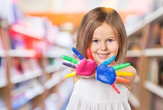 A happy girl with painted hands